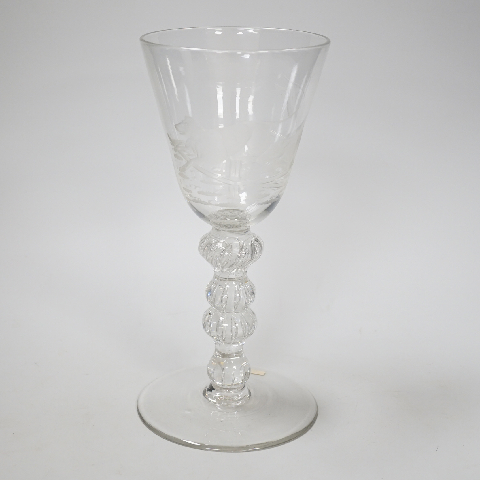 An English lead crystal mammoth trophy goblet, 19th century / early 20th century, engraved with two racing greyhounds, coats numbered 1 and 2, leaping a hurdle, four knopped multiple teared stem and a wide foot with brok